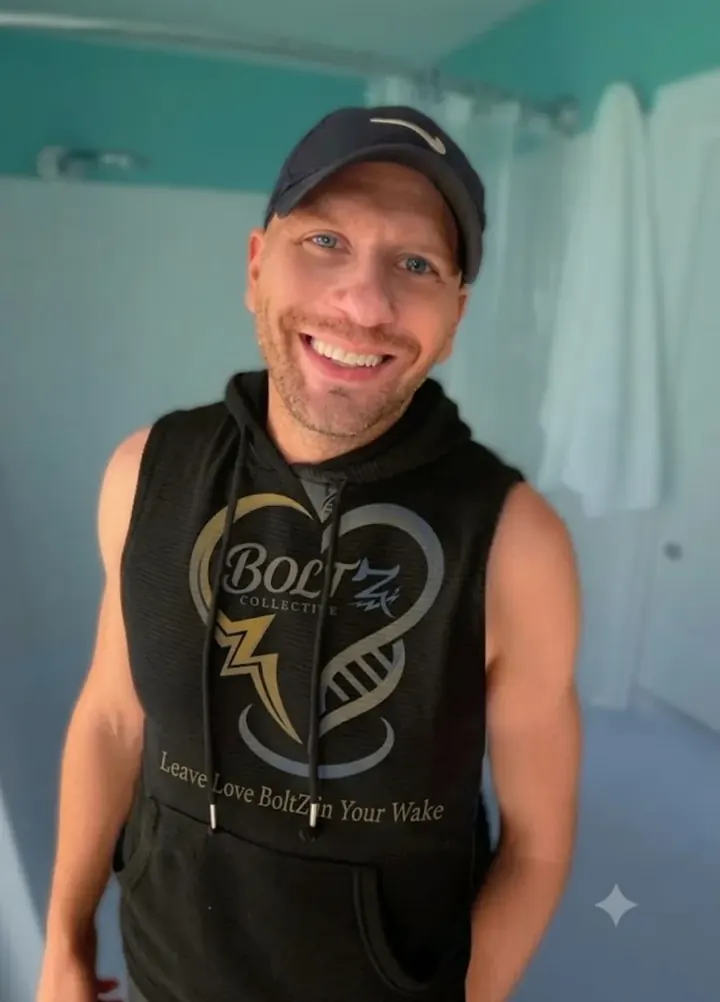 Tony JaXon BoltZ smiling in a Leave Love BoltZ in Your Wake hoodie